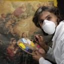 Restoration artist working on a piece of art