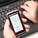 Person reading looking at a security code on their smartphone