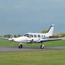 A small airplane landing on a private airstrip