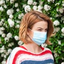 woman wearing a protective mask to protect herself from pollen during spring allergies