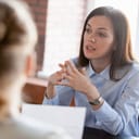 a woman discussing a harassment issue with an HR representative
