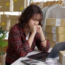 Young attractive asia female hipster thoughtful serious doubtful feeling stress worry with financial problem in SME crisis small business challenges impact from covid coronavirus at home office.