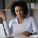 Confused woman dismissingly looking at a piece of paper
