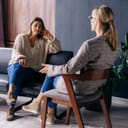 A psychologist sitting with a client talking