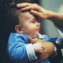 A priest blessing a baby