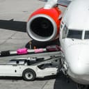 unloading luggage from a plane