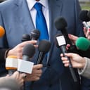 Journalists interviewing VIP