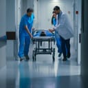 Medical team in Emergency Department rushing a seriously injured patient on a gurney to the operating room