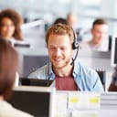 A customer service worker talking with a customer using a headset