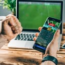 man checking live score of a match