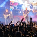 Music band performing in front of a crowd of fans