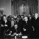 President Lyndon B. Johnson signing the 1964 Civil Rights Act, witnessed by Martin Luther King, Jr. and other civil rights leaders.