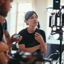 Filmmakers at a set looking at a camera screen