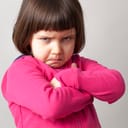 Small girl scowling