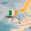 Irish flag pin on map of Western Europe.
