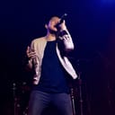 A man on a stage singing into a microphone
