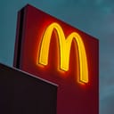 Close-up of a brightly illuminated McDonald's sign.