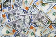 $100 bills scattered around