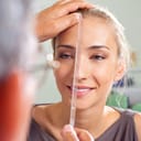 A plastic surgeon checking a woman's nose