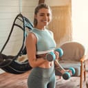 Young fit women holds exercise weights