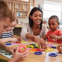 Female teacher playing with toddlers
