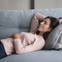 A relaxed woman having a nap on a sofa