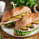 Healthy rye bun sandwiches with ham and pickled cucumbers.