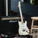 Electric guitar resting against an amplifier in a studio