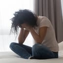 Devastated woman sitting on the bed