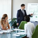 Business man, speaker or presentation of corporate management team with sustainable growth chart. Training, people or collaboration of eco friendly company staff in conference room for report meeting