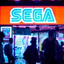 Large neon SEGA logo sign in focus