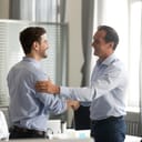 Two men shaking hands in an office