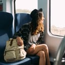 A girl looking out of the train window while traveling