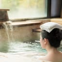 Young girl with a towel on her head enjoying hot springs