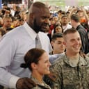 Army National Guard members pose for a photo with NBA star Shaquille O'Neal.