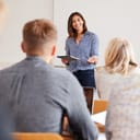 College Tutor With Digital Tablet Teaches Mature Students