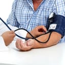 Older man measuring blood pressure at the doctor's