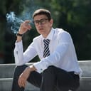 A young businessman smoking in public