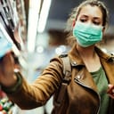 Young woman wearing a face mask in public