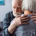 Elderly couple hugging each other