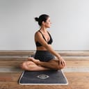 A woman doing yoga on the floor