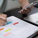 person planning with a colorful planner pen and smartphone