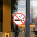 "No Smoking" sticker on a glass door