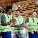 Three construction workers sharing a laugh on a break