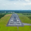Runway 19 at Nakorn Sri Thammarat, Thailand, bordered by green grass