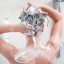 A woman washing her hair in the shower