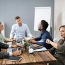 A boring, unproductive team meeting in the meeting room, while a surprised woman glances at her watch to check the time.