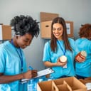Volunteers in blue t-shirts separating food and noting everything down in a notepad