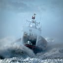 close-up of a coast guard boat in the midst of an ocean storm