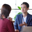 A woman and a man in business attire talking to each other